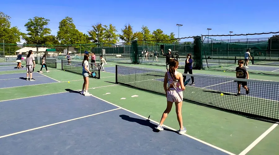 Junior pickleball player aged 8–12 at Reno Tennis Center youth program, beginner stage