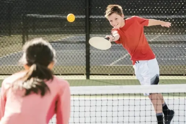 Junior pickleball players training with coach at the Reno Tennis Center
